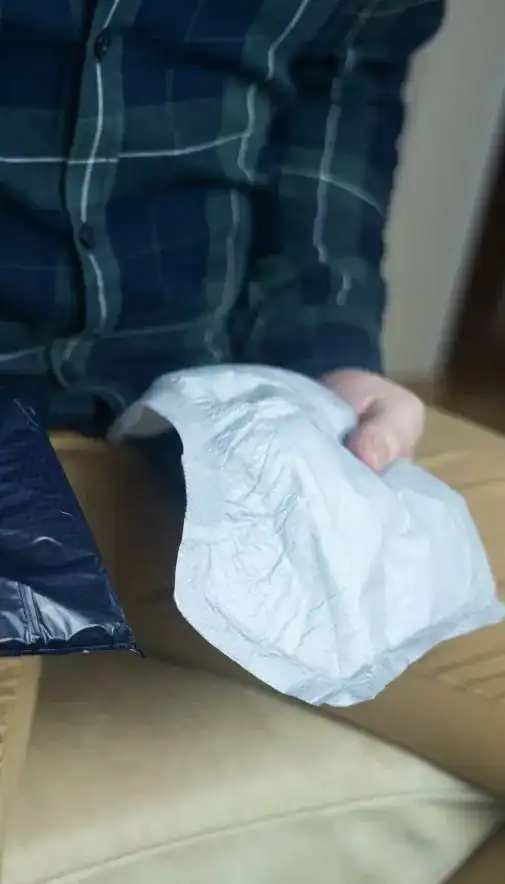 Image of man holding incontinence pads as part of overactive bladder treatment Kingston upon Hull